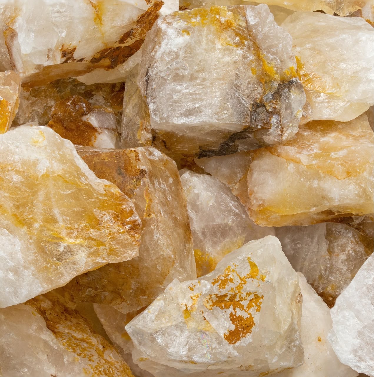 Raw hematoid quartz crystals with golden hematite inclusions from Minas Gerais