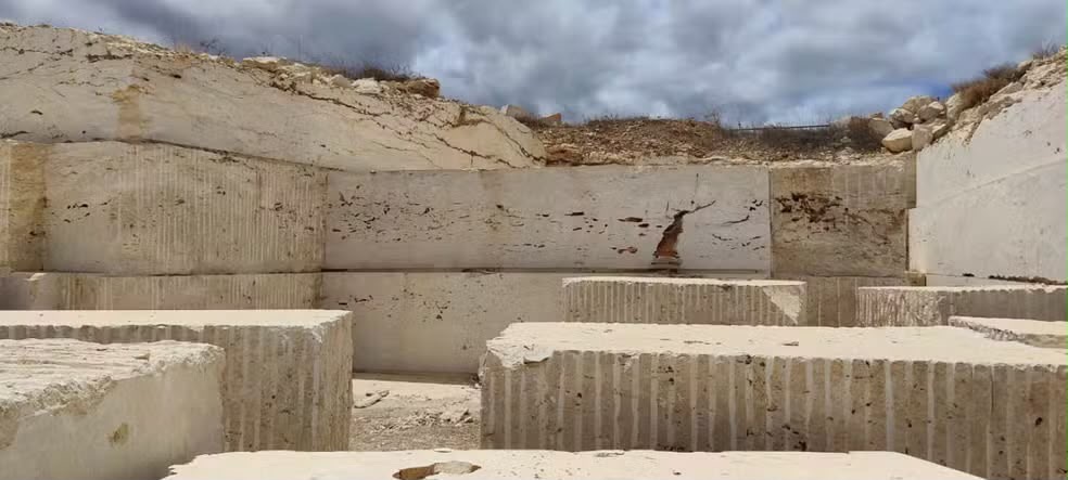 Bahia Beige travertine quarry with cut blocks of light beige stone