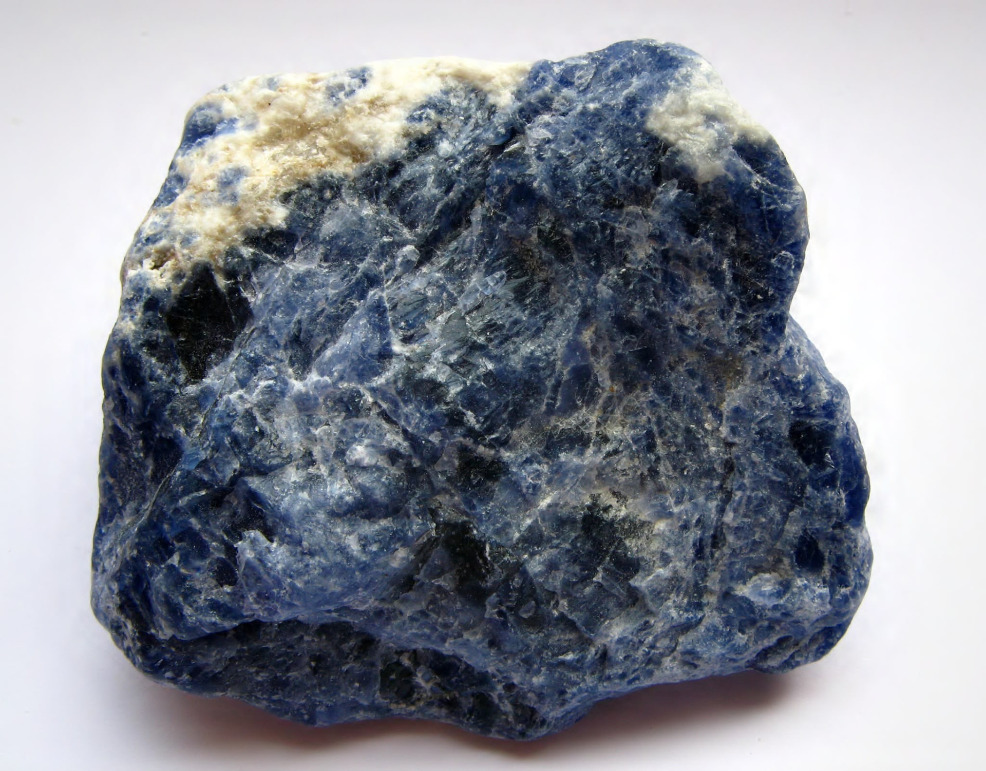 Raw blue sodalite block with white calcite veins from southern Bahia